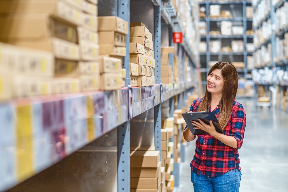 asian-woman-warehouse-worker-standing-and-checking-2022-10-06-05-36-44-utc-1