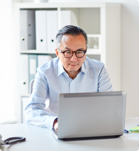 businessman-in-eyeglasses-with-laptop-office-P65XXT9 1