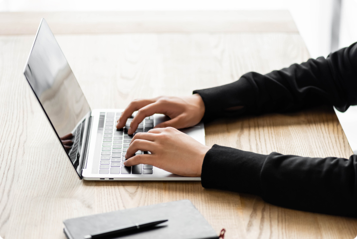person on laptop checking if the comapny is security compliant person on laptop checking if the comapny is security compliant