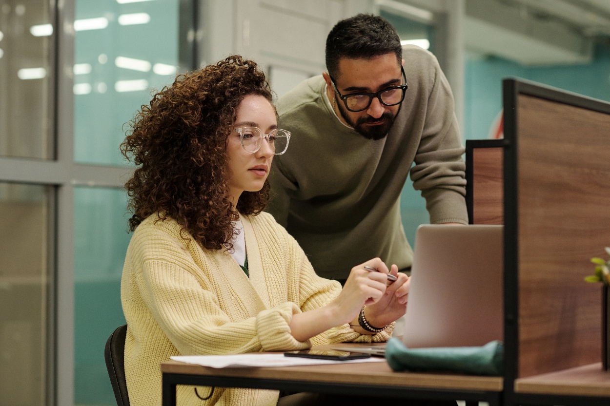 two-young-colleagues-looking-through-data-on-lapto-2022-07-14-18-03-46-utc-1